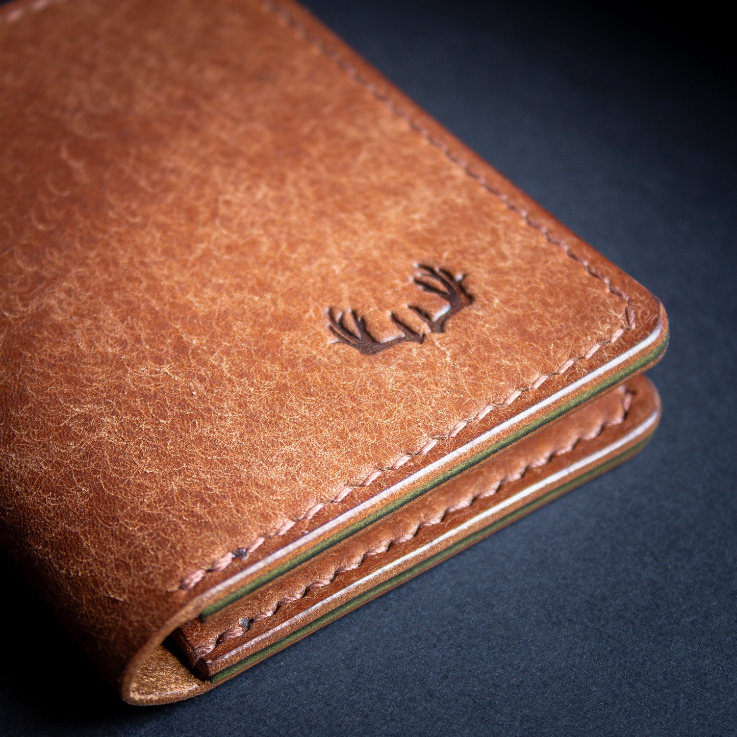 leather bifold wallet brown shiny edges with antler logo