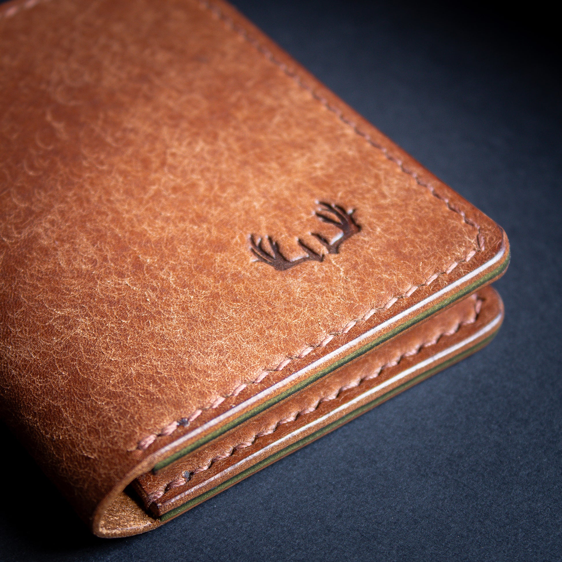 leather bifold wallet brown shiny edges with antler logo