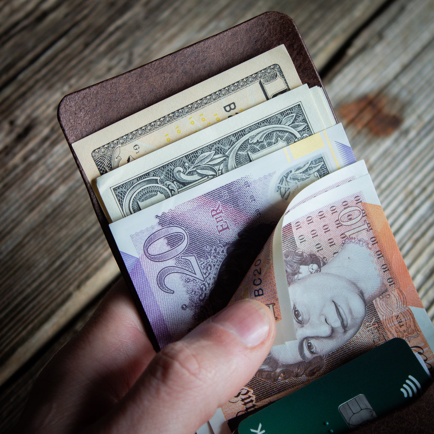 EDC flap brown wallet - close up unfolded UK cash and unfolded US Bills