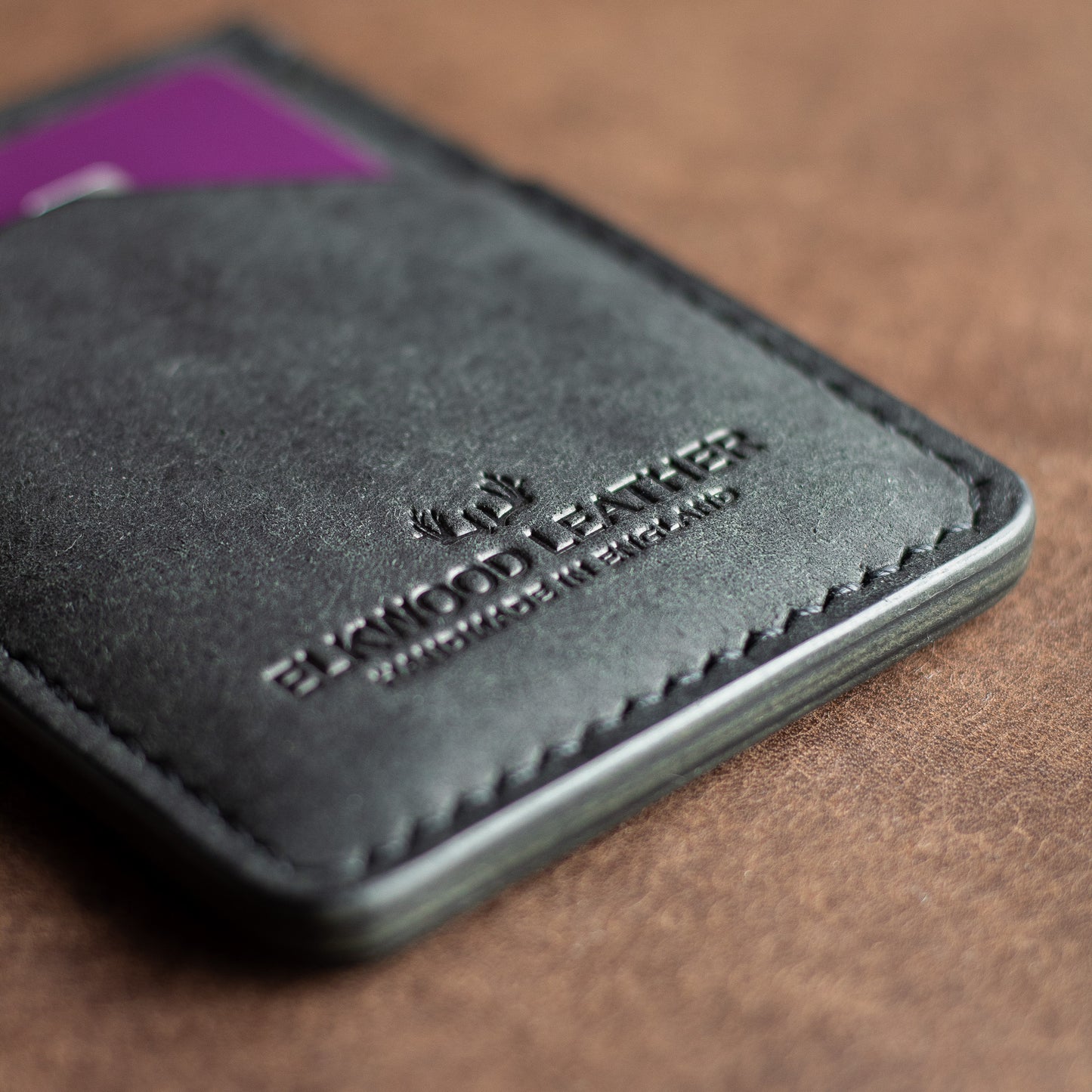 Elkwood leather logo on a black pueblo leather with shiny edges