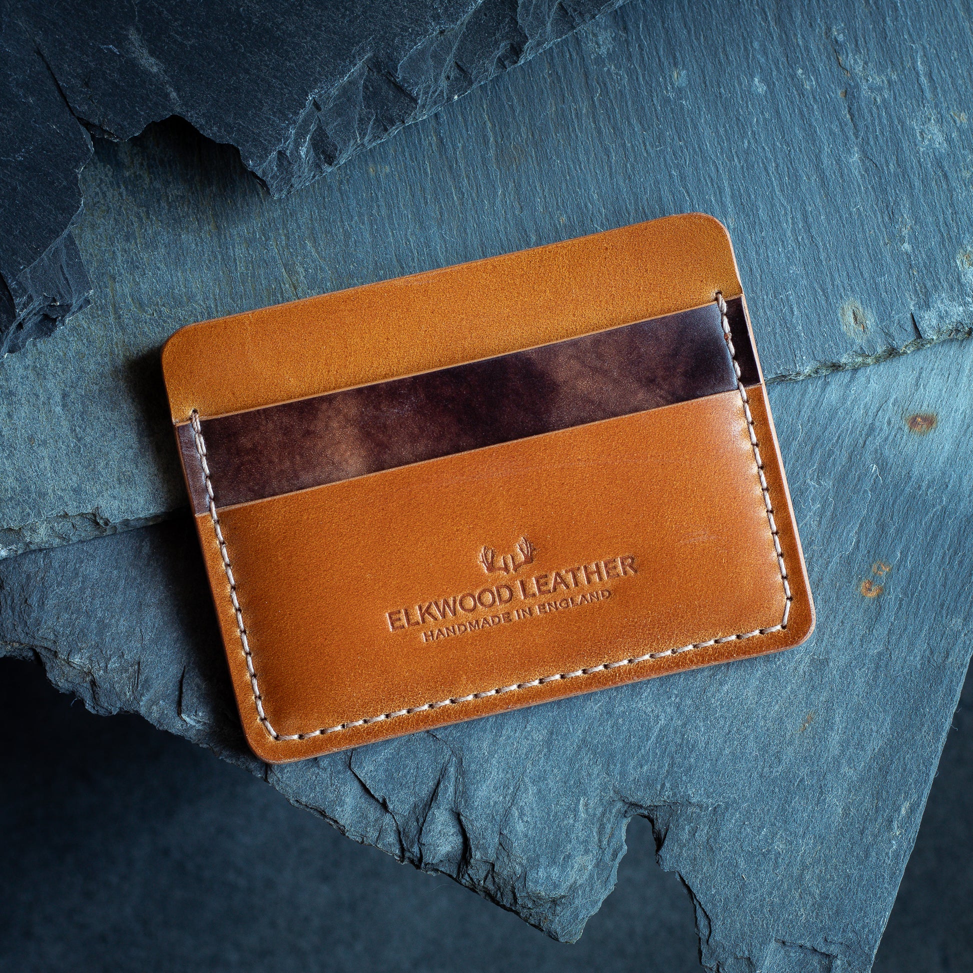 Shell cordovan leather cardholder wallet onto of slate, crafted from Rocado Whiskey & Brown Museum Leather