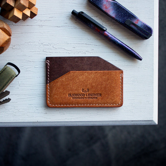 Elkwood Leather - The Aspen - minimalist full grain Italian Pueblo leather cardholder wallet on white wooden table next to galaxy tactile turn pen and knife and keys