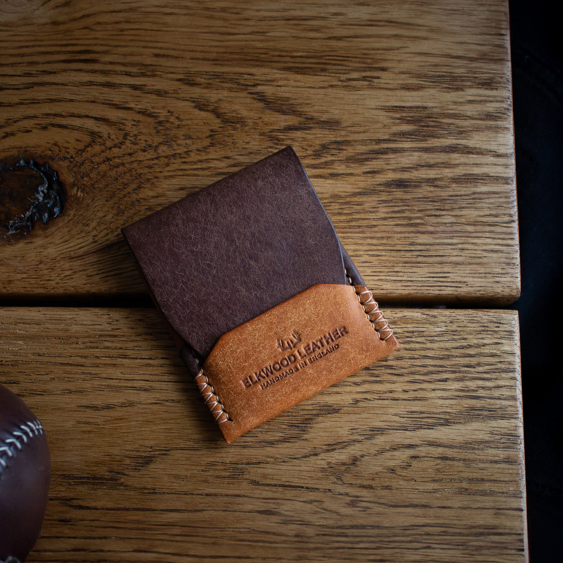 PDF TEMPLATE Elkwood Leather - The Blackthorn - EDC Flap full grain Italian Pueblo leather cardholder wallet closed wooden table next to brown leather baseball