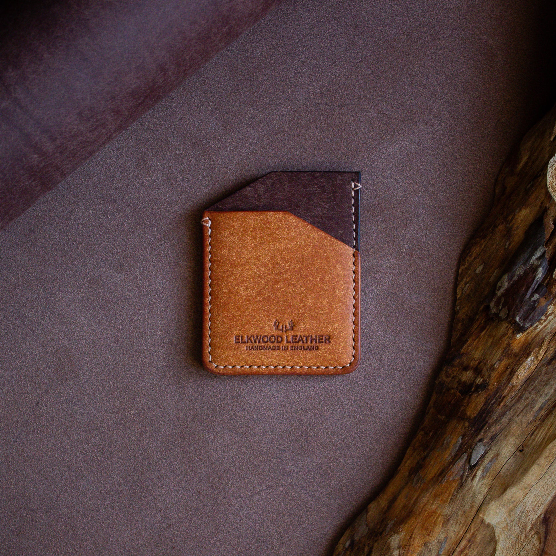 LEATHER DIY TEMPLATE - Elkwood Leather - The Maple - minimalist full grain Italian Pueblo leather cardholder wallet on roll of leather next to wood grain