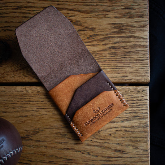 Elkwood Leather - The Blackthorn - EDC Flap full grain Italian Pueblo leather cardholder - brown leather wallet open wooden table next to brown leather baseball