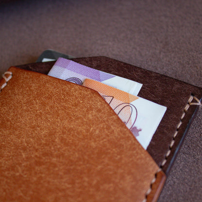 Elkwood Leather - The Maple - minimalist full grain Italian Pueblo leather cardholder wallet close up of pocket with cash and credit cards on roll of leather next to wood grain