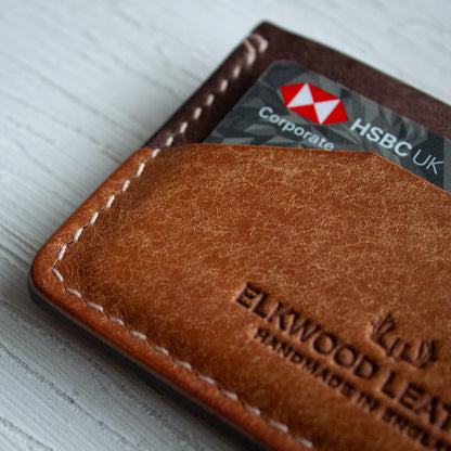Elkwood Leather - The Aspen - minimalist full grain Italian Pueblo leather cardholder wallet on white wooden table next to galaxy pen and knife and keys close up of stitching