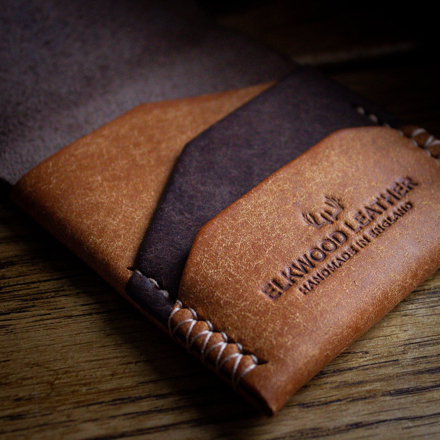 Elkwood Leather - The Blackthorn - EDC Flap full grain Italian Pueblo leather cardholder wallet open close up of pockets on wooden table next to brown leather baseball