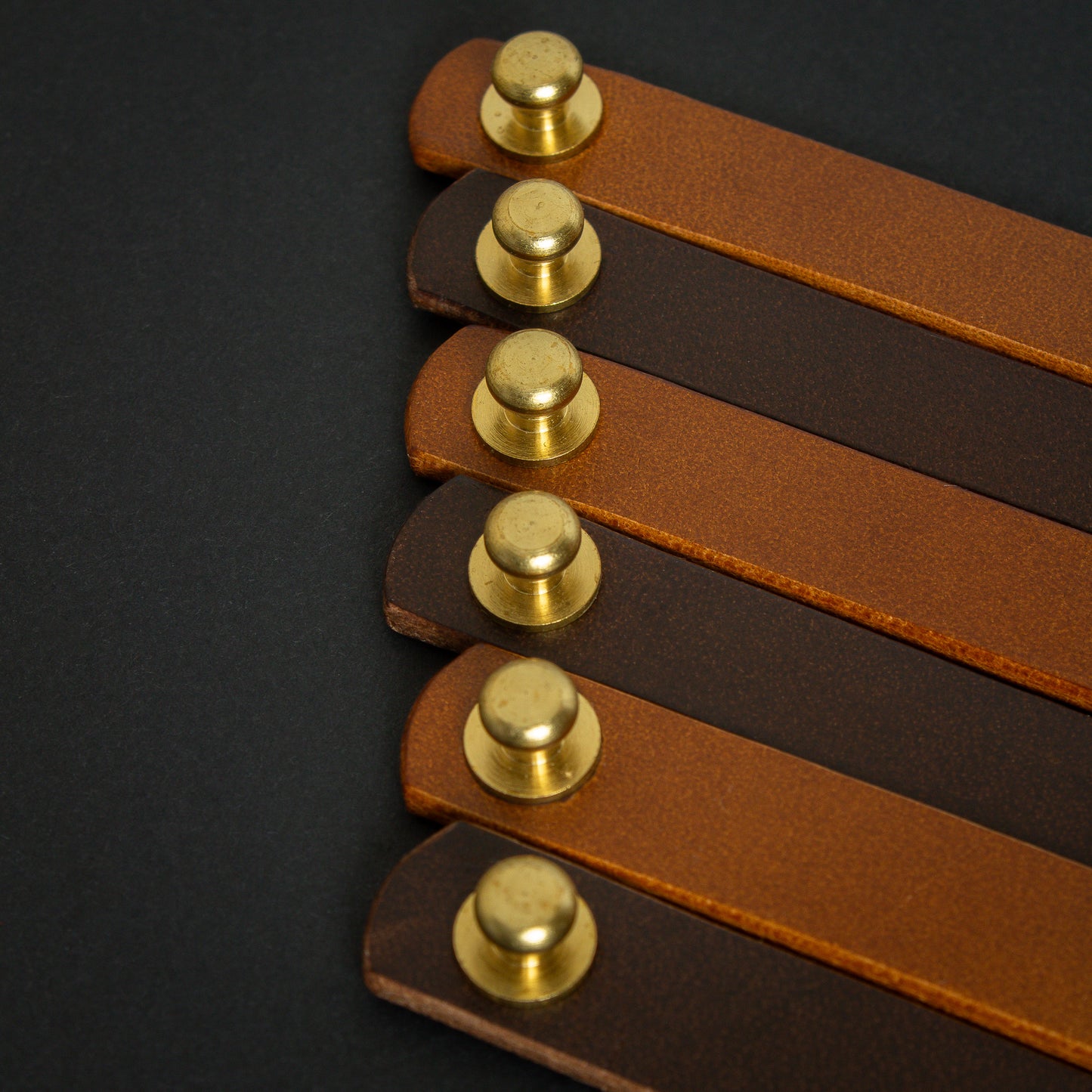 handmade leather wrist bands with solid brass sam browne studs - made from Buttero leather close up brass studs