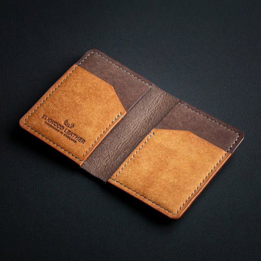 handcrafted brown leather wallet ontop of black background - open leather cardholder - Badalassi Carlo Pueblo Cognac and Castagno leather - elkwood leather stamp