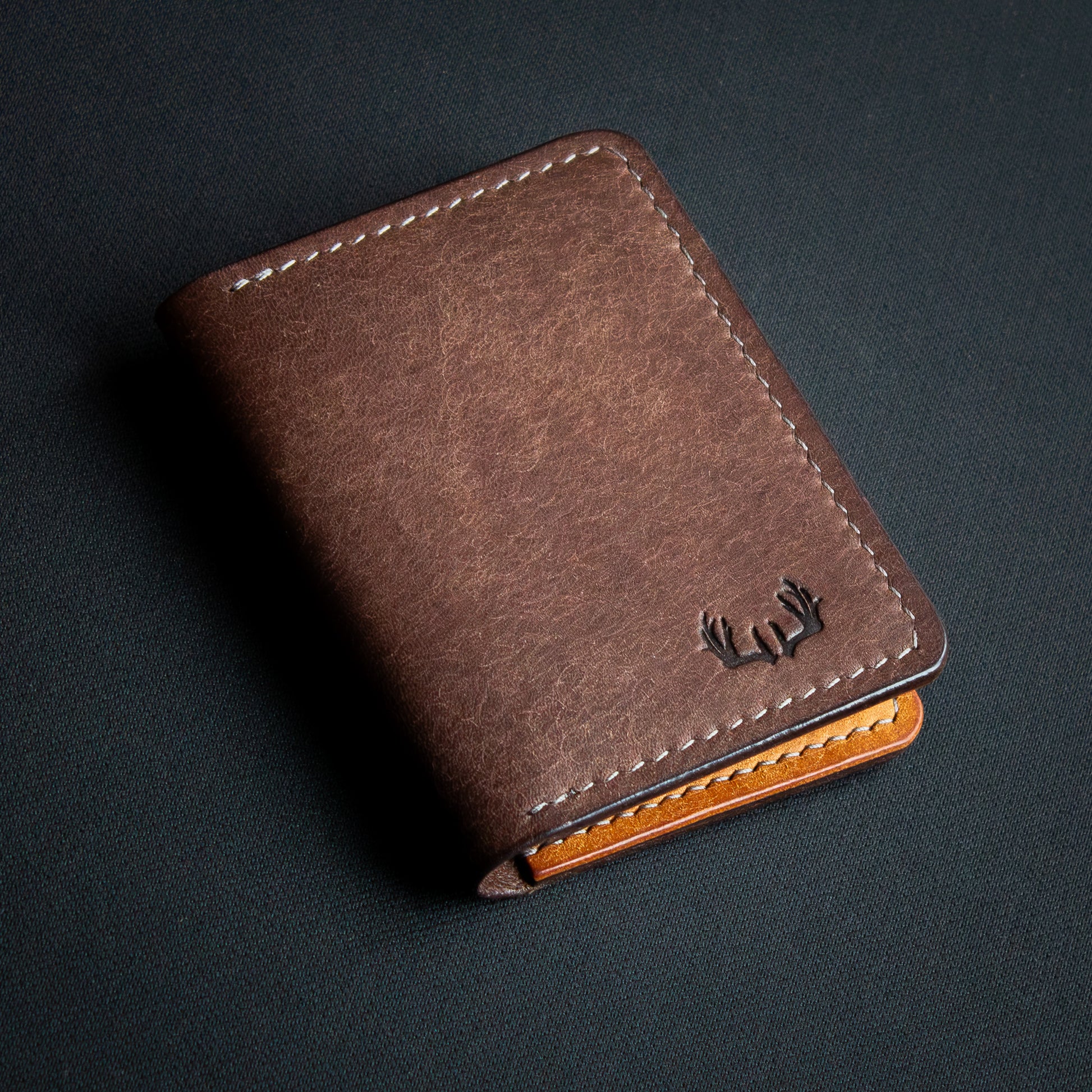 handcrafted brown leather wallet ontop of black background - open leather cardholder - Badalassi Carlo Pueblo Cognac and Castagno leather - closed with brown elkwood leather stamp