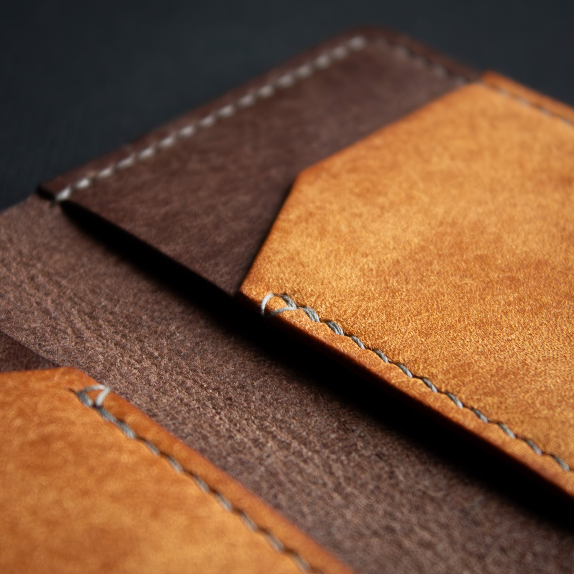 handcrafted brown leather wallet ontop of black background - open leather cardholder - Badalassi Carlo Pueblo Cognac and Castagno leather - close up saddle stich with grey xiange thread 