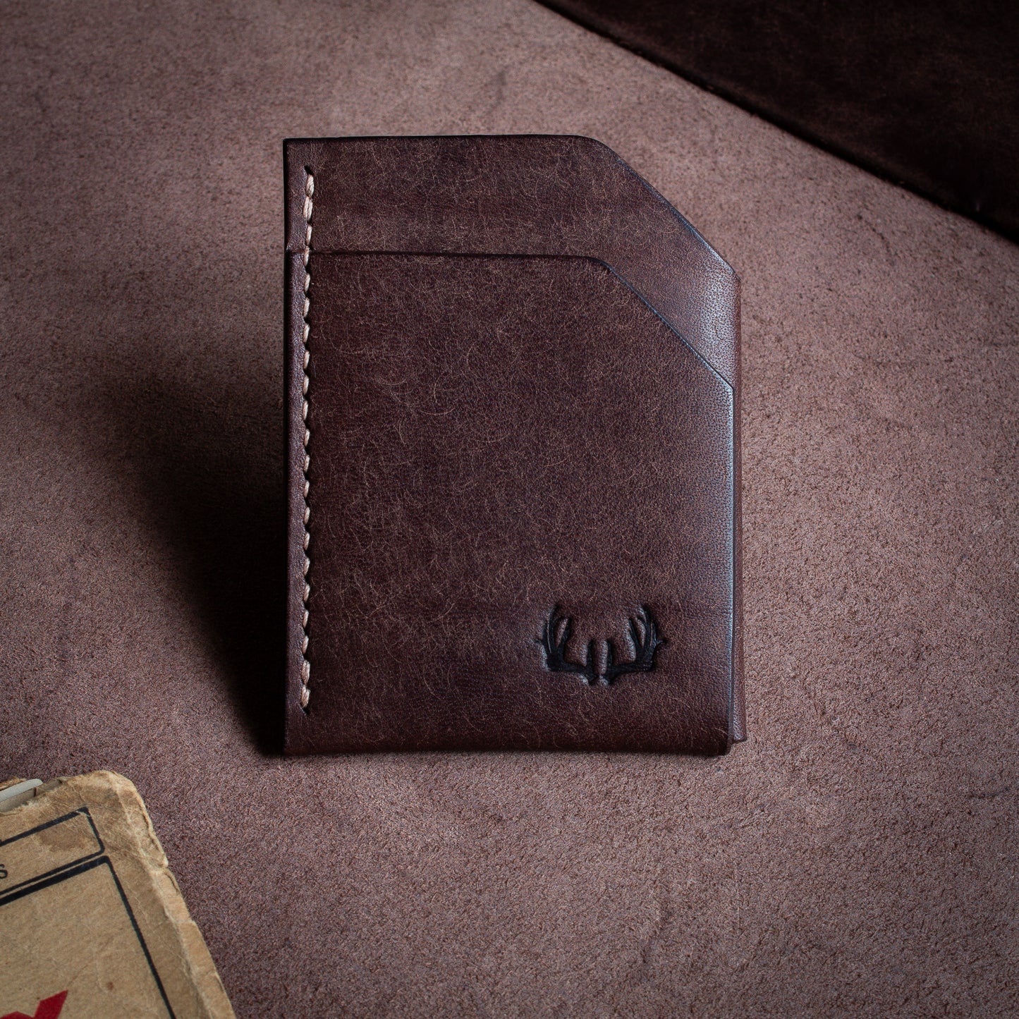 Folded handmade leather edc wallet with contrasting stitching made from Pueblo leather by Badalassi - Castagno