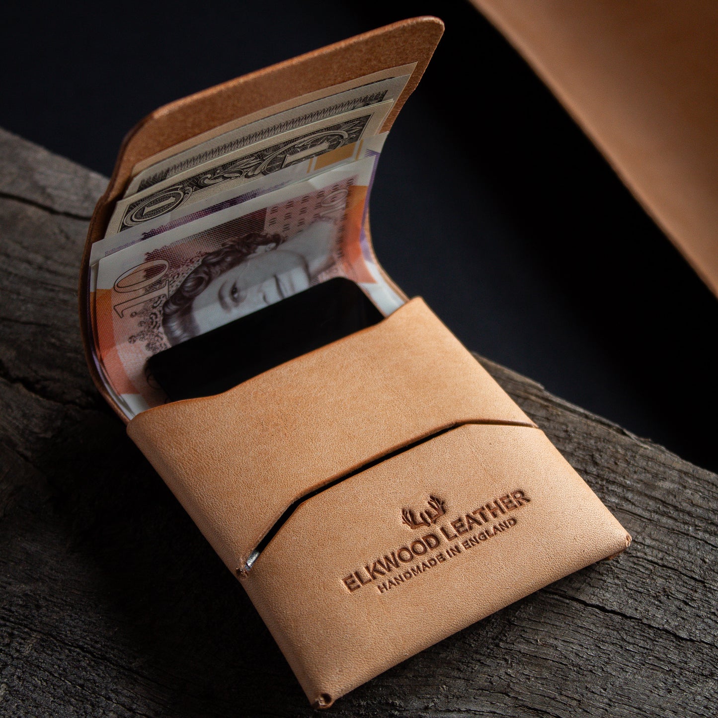 Everyday carry stitches wallet in natural vegetable tanned leather - open with unfolded cash and cards