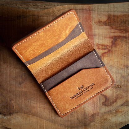 Brown leather bifold wallet open with card slots