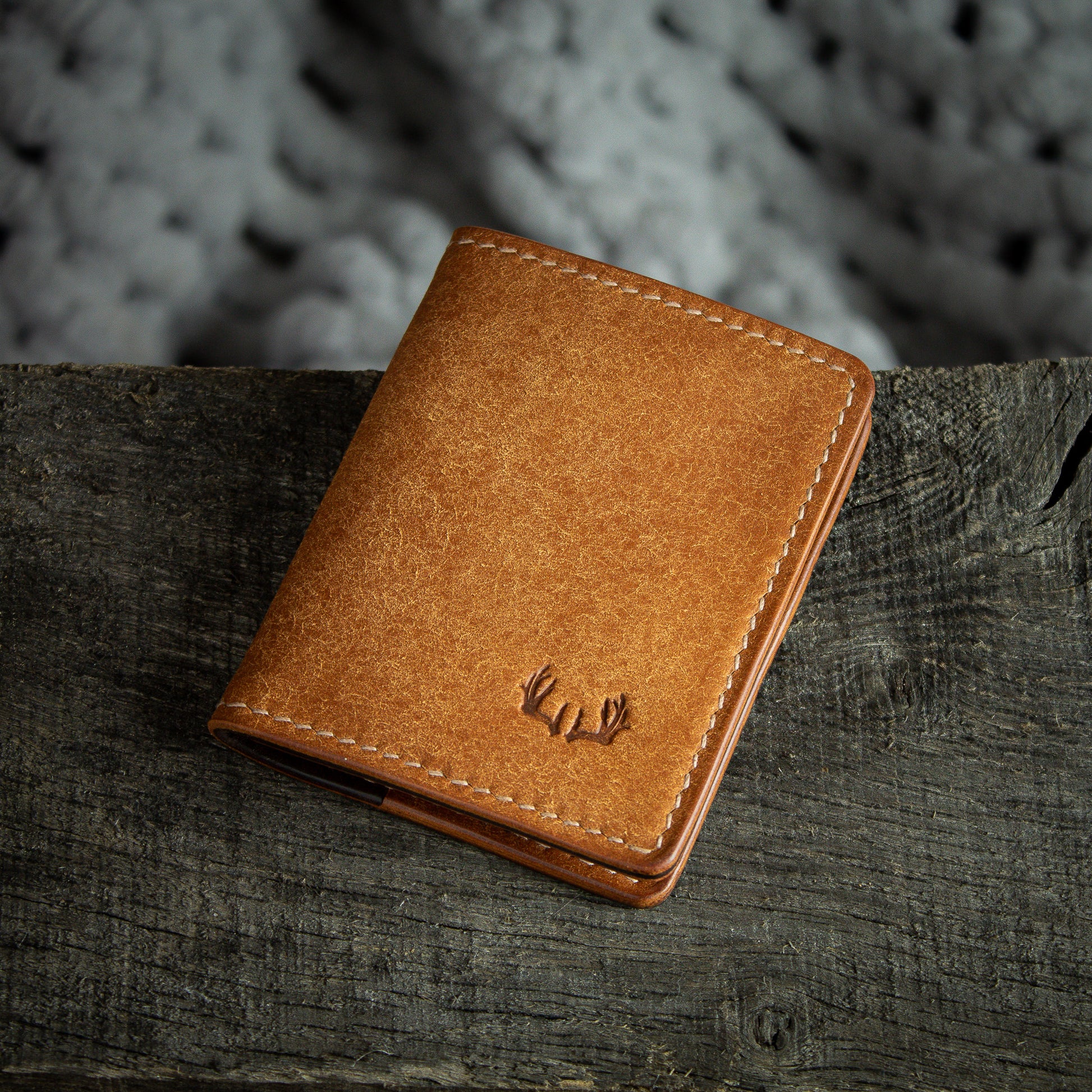 Elkwood Leather - The Cedar - Bi-fold full grain Italian Pueblo leather cardholder wallet closed front with small antler horn logo onto of rugged wood