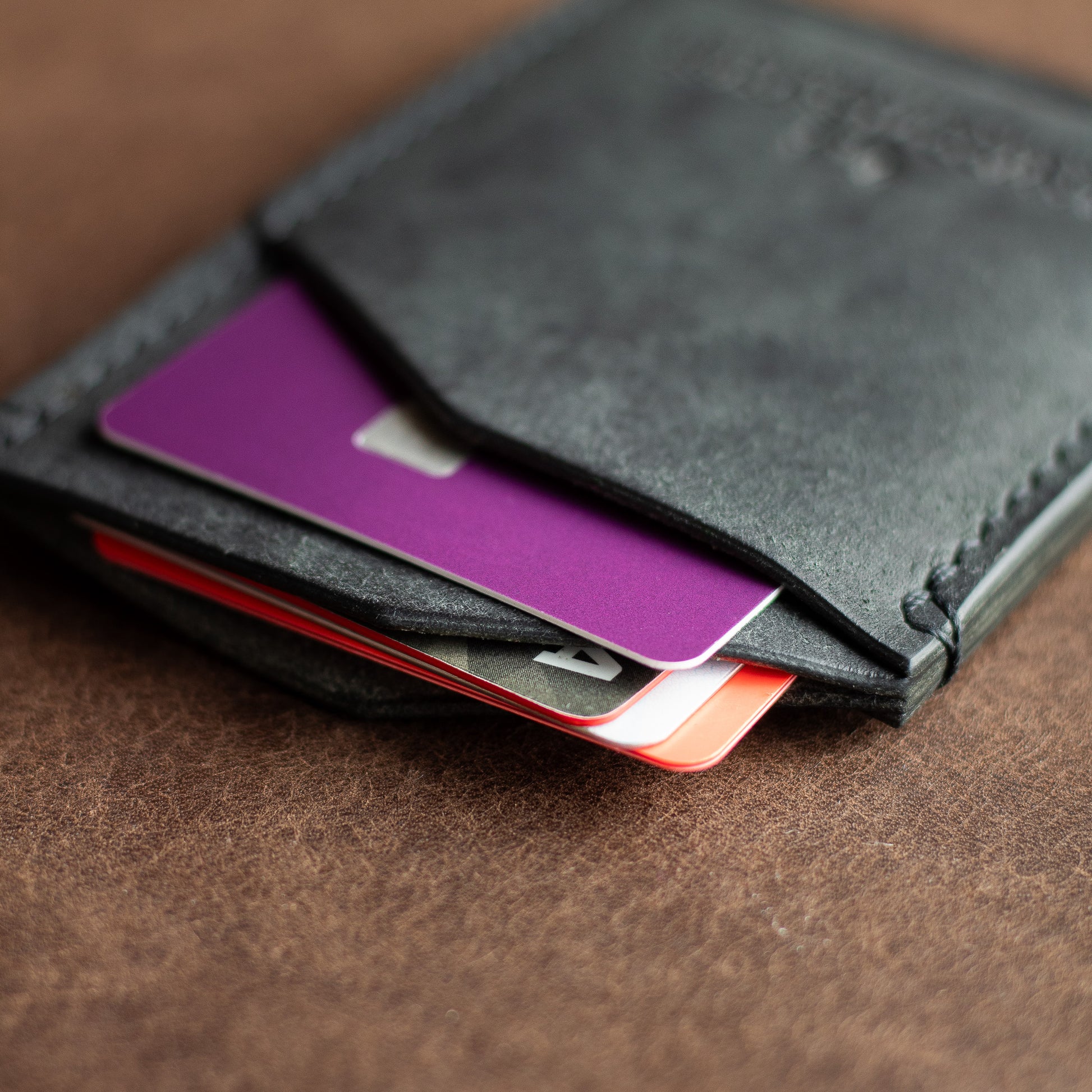 credit cards inside a full grain black leather cardholder wallet